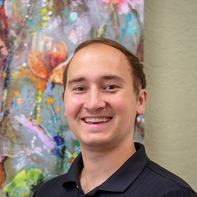 Chiropractor Austin Smiciklas Smiling In Polo Shirt